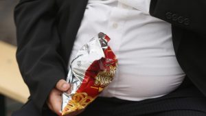 LEIPZIG, GERMANY - MAY 23: A man with a large belly eats junk food on May 23, 2013 in Leipzig, Germany. According to statistics a majority of Germans are overweight and are comparatively heavier than people in most other countries in Europe. (Photo by Sean Gallup/Getty Images)